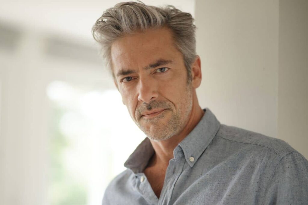 Mature man with confident expression showing typical recovery progress after male lip lift surgery.