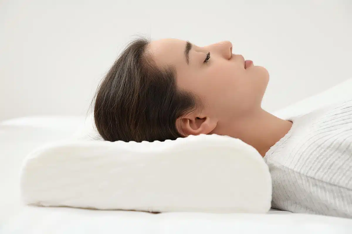 woman laid down after facelift surgery using a special pillow